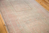 Distressed vintage Turkish Oushak runner with subtle design and faded pink, beige tones.