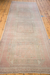 Distressed vintage Oushak runner texture, soft peach and light grey geometric design.