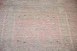 Distressed vintage Turkish runner pile, with faded rose and beige subtle design.