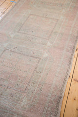 Distressed vintage Turkish Oushak runner showing faded rose hues and subtle geometric texture.