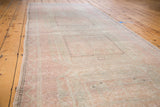 Distressed Turkish Oushak runner with faded peach, beige hues and subtle geometric design.
