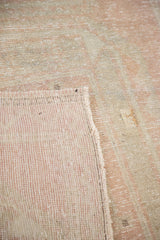 Distressed vintage Turkish Oushak runner's hand-knotted back and faded peach-beige pile.