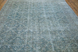Blanched ocean green blue tones and distressed texture of a vintage Oushak carpet.