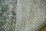 Distressed blanched ocean green blue pile contrasting with a tightly woven beige rug foundation.