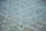 Distressed Oushak rug with blanched ocean green-blue allover lattice and faded texture.