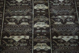 Dark brown and beige pictorial patterns of cars and tanks on a Vintage Afghan rug.