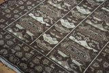 Hand-knotted Afghan war rug detail showing stylized beige military vehicles on brown.