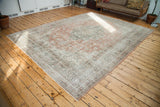 Distressed Oushak rug with faded blanched rust, silver, ivory patterns under natural light.
