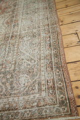 Distressed Oushak carpet surface in faded blanched rust, silver, and ivory.