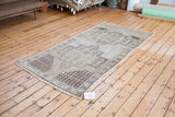 Neutral beige and brown geometric patterns and soft fringe of a vintage Oushak rug.