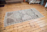 Geometric patterns of a vintage Oushak rug in a neutral beige and brown palette.