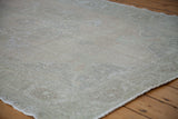 Thin, subtly textured pile of the vintage Oushak rug in airy light tones.