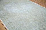 Subtle light tones and airy, faded pattern of a vintage Oushak rug.