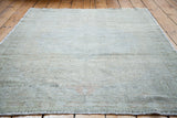 Subtle light-toned vintage Oushak rug with soft, faded traditional patterns.