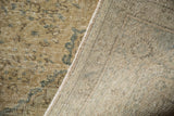 Distressed Oushak rug pile revealing faded colors and its neat, woven foundation.