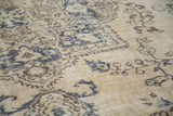 Blanched beige vintage Oushak with faded dark gray contrasting patterns.