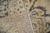 Vintage Oushak rug close-up showing hand-knotted weave and blanched beige pattern.