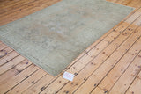 Distressed texture with soft beige and slate green tones on an Oushak rug.
