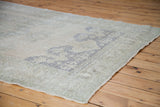 Vintage Oushak carpet corner, showing beige, grey, and slate blue pattern detail.