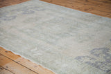 Faded hand-knotted pile texture of vintage Oushak rug in beige, grey, and slate blue.