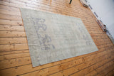 Vintage Oushak carpet with a light, airy feel in beige, grey, and slate blue.