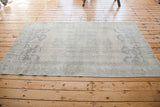 Vintage Oushak rug featuring soft beige, grey, and faded slate blue motifs, mid-20th century.