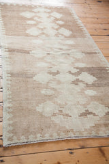 Detail of vintage Oushak runner's tone-on-tone simplistic geometric pattern in cream and beige.