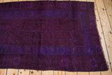 Textured deep violet purple pile with subtle patterns and side edge.