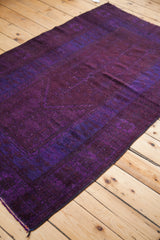Deep violet purple and subtle royal blue tones on a blanket-like overdyed Oushak rug.