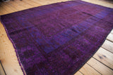 Deep violet blue overdyed Oushak rug pile with blanket-like texture and fringed edge.