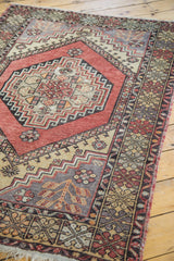 Geometric border and stylized leaf design on muted grey ground of vintage Oushak rug.