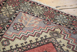 Vintage Turkish Oushak rug corner with geometric patterns and stylized vine motifs.