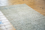 Distressed vintage Sivas rug, soft abrashed sea foam green with faded allover design.