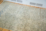 Distressed texture with subtle floral motifs on abrashed sea foam green field of a vintage Sivas rug.