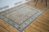 Traditional Kayseri rug's curvilinear border and allover beige field with dark cloudbands.