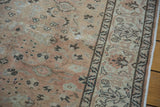 Detail of a vintage Sivas rug showing the soft beige field with subtle cloudbands and ornate border.