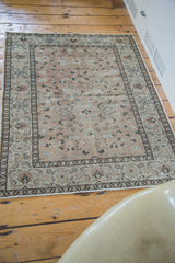 Lower view of vintage Sivas rug, featuring its soft beige field and cloudband motifs.