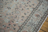 Vintage Sivas rug detail: soft beige field, allover cloudband design, and decorative border.