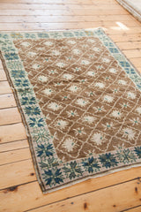 Vintage Oushak rug border with blue-green geometric pattern and brown field lattice motif.
