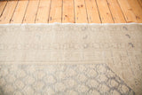 Softened grey and silver white patterns on a distressed Oushak rug pile.