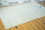 Distressed modern Oushak rug with light ivory tones and subtle oblong lattice lozenges.
