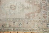 Sandy beige field with stepped medallion edge and geometric border on vintage Oushak rug.