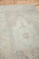 Stepped arch motif within the sandy beige field of the vintage Oushak rug.