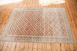 Distressed Oushak rug corner with unique geometric border and tone-on-tone lattice pattern.