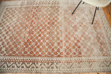 Distressed vintage Oushak carpet with faded peach and ivory tone-on-tone lattice design.