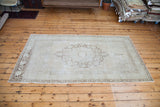 Blanched aesthetic of this Vintage Oushak rug with sun-faded bronze and peach.