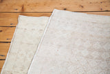 Reverse side of the distressed Oushak rug, highlighting hand-knotted foundation in muted beige.