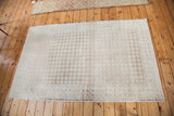 Distressed Oushak rug with tone-on-tone silver, beige, and ivory harlequin abrashes.