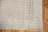 Partial view of distressed Harlequin Oushak rug in softened beiges and antique ivory.