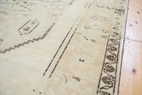 Faded charcoal floral border and geometric motifs on vintage Oushak rug.